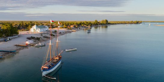 A sailing boat cruises along the peaceful waters near Morondava in southwest Madagascar