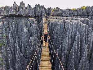 A tourist crosses the suspension bridge in the Tsingy national park