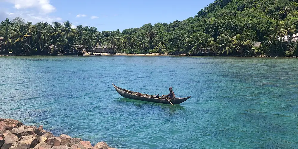 A man paddles past in a traditional Malagasy pirogue (canoe)