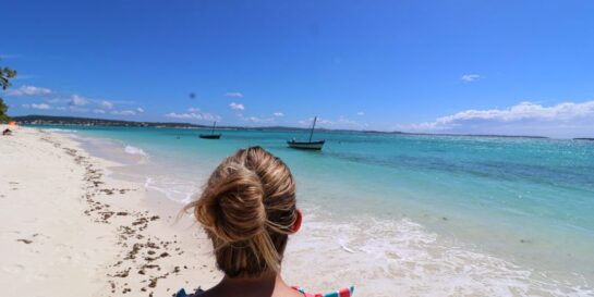 A woman looks at the stunning emerald sea