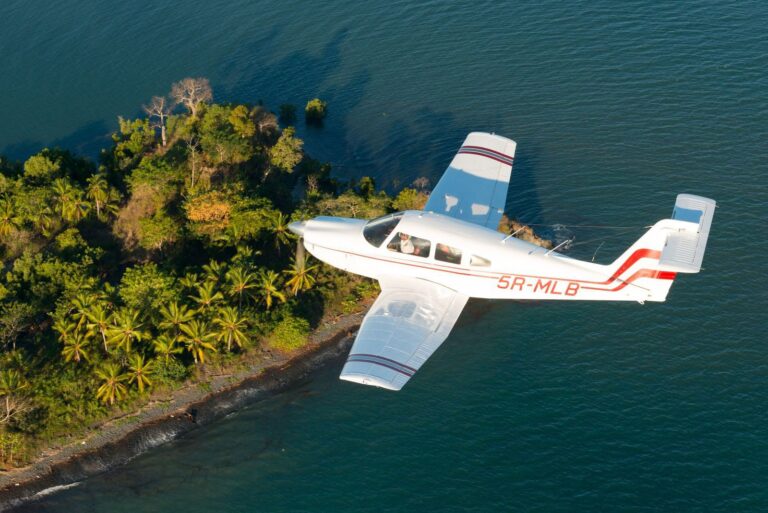 A small private charter plane flies over an island