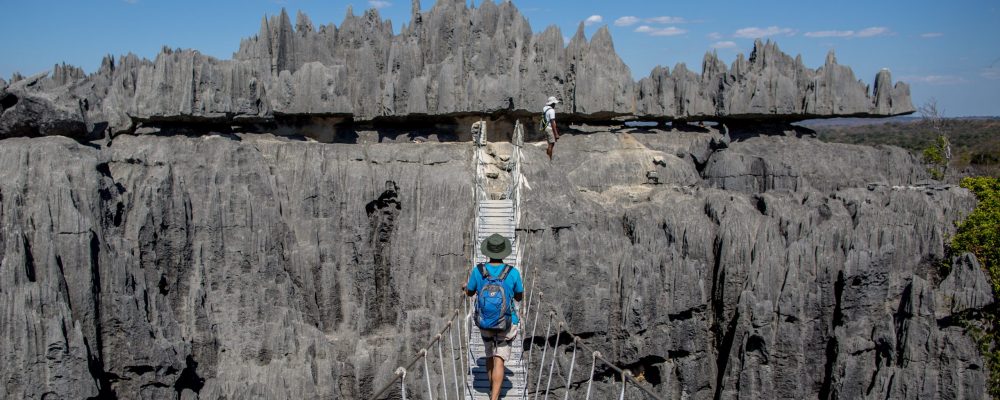 A tourist walks across a bridge in the Tsingy national park